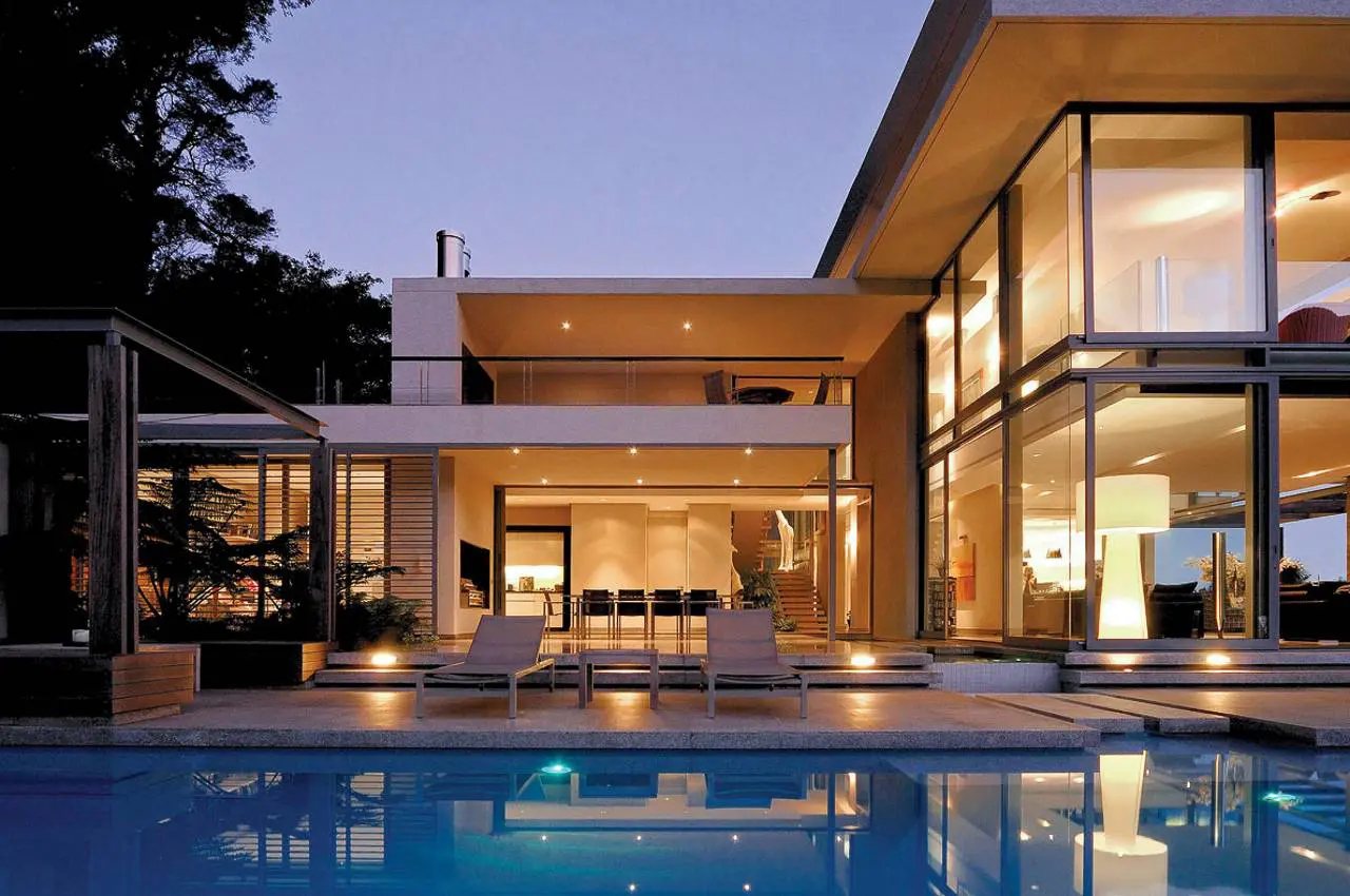 Contemporary glass house with illuminated interior